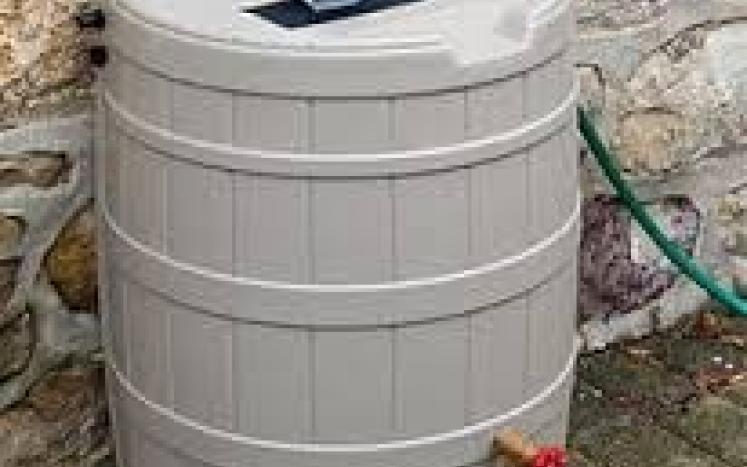 PHoto of rain barrel with downspout